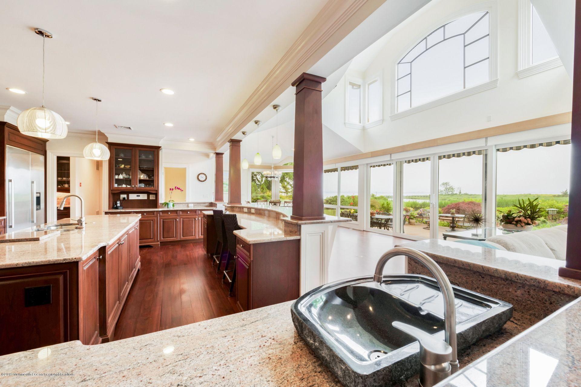 10 Edwards Point Road Rumson, NJ 07760 - Photo 3 of 40 a kitchen with stainless steel appliances granite countertop a sink dishwasher a stove and a refrigerator with wooden floor