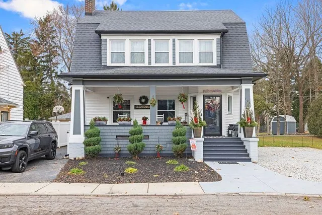 a view of a house with a patio and a yard