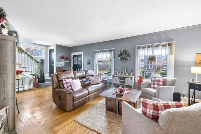 a living room with furniture a flat screen tv and a fireplace