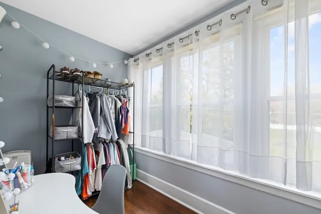 a bedroom with furniture and a flat screen tv