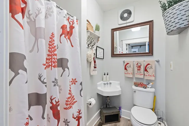 a view of a dining room with furniture a chandelier and wooden floor