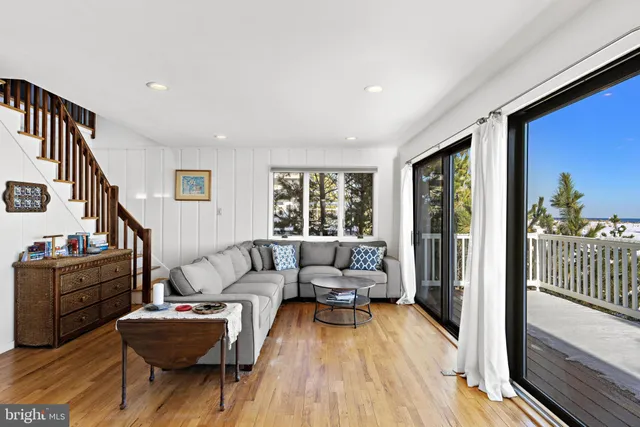 a living room with furniture windows and a flat screen tv