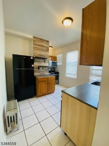 a kitchen with stainless steel appliances a refrigerator sink and microwave