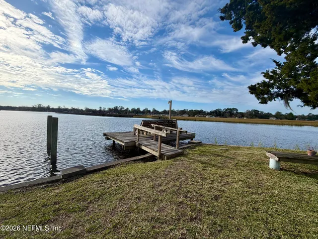 a view of a lake with houses in the back yard