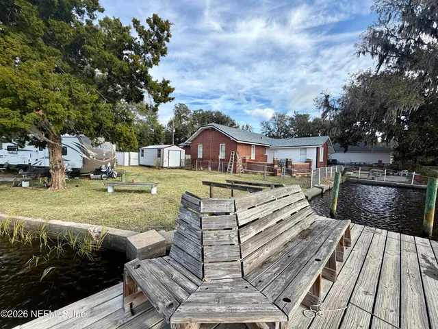 a view of a house with swimming pool and sitting area