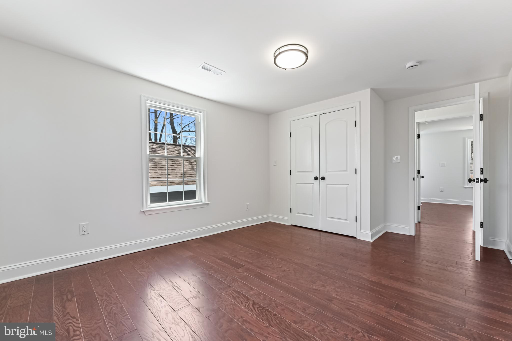 1637 Fairhill Drive Edgewater, MD 21037 - Photo 19 of 46 an empty room with wooden floor and windows
