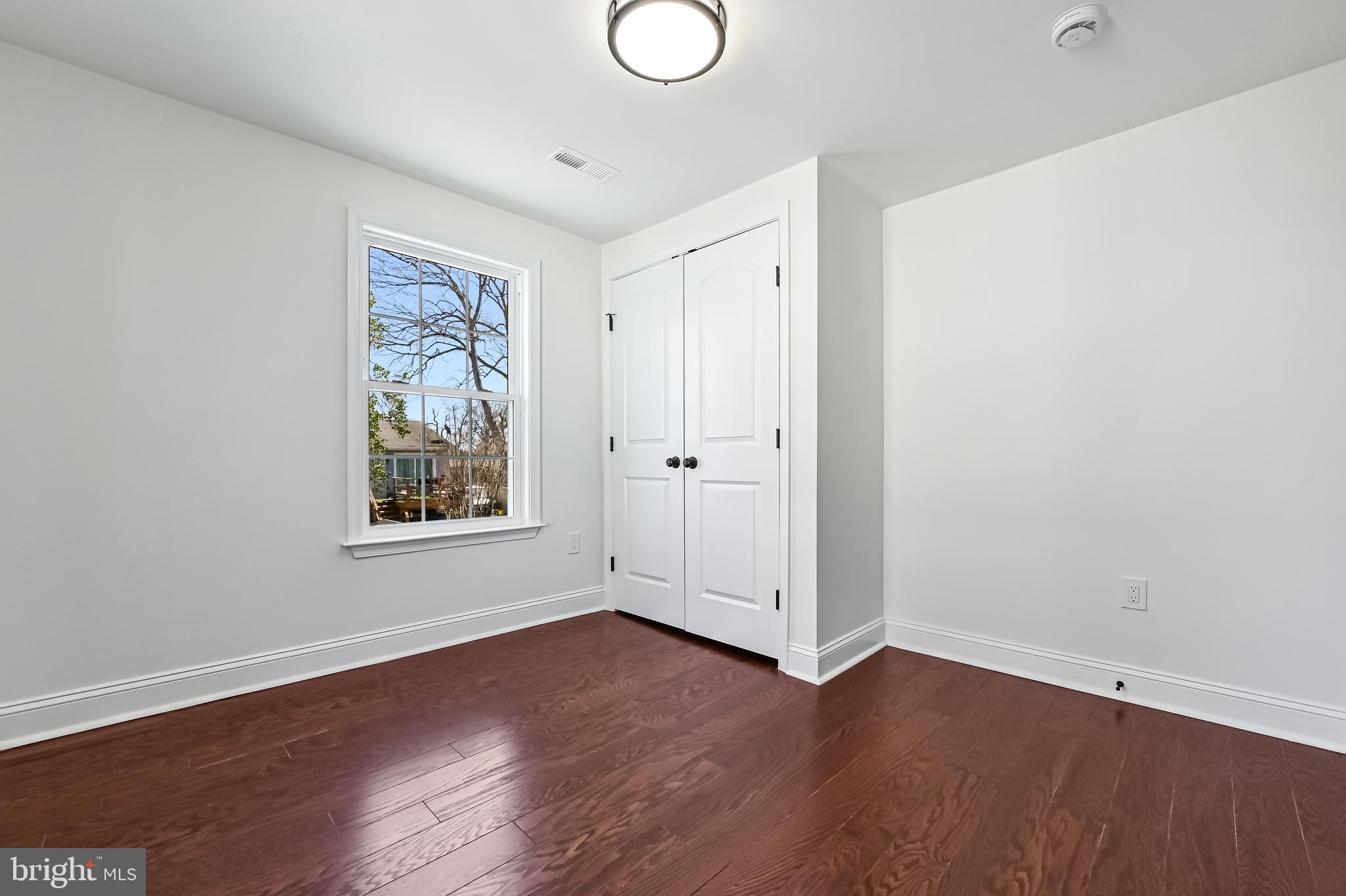 1637 Fairhill Drive Edgewater, MD 21037 - Photo 27 of 46 an empty room with wooden floor and window