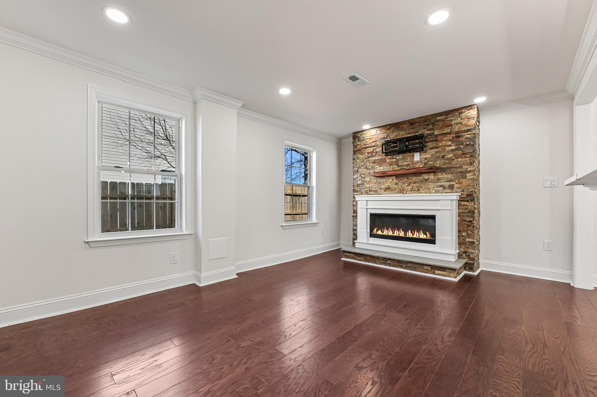 1637 Fairhill Drive Edgewater, MD 21037 - Photo 6 of 46 a view of an empty room with wooden floor fireplace and a window