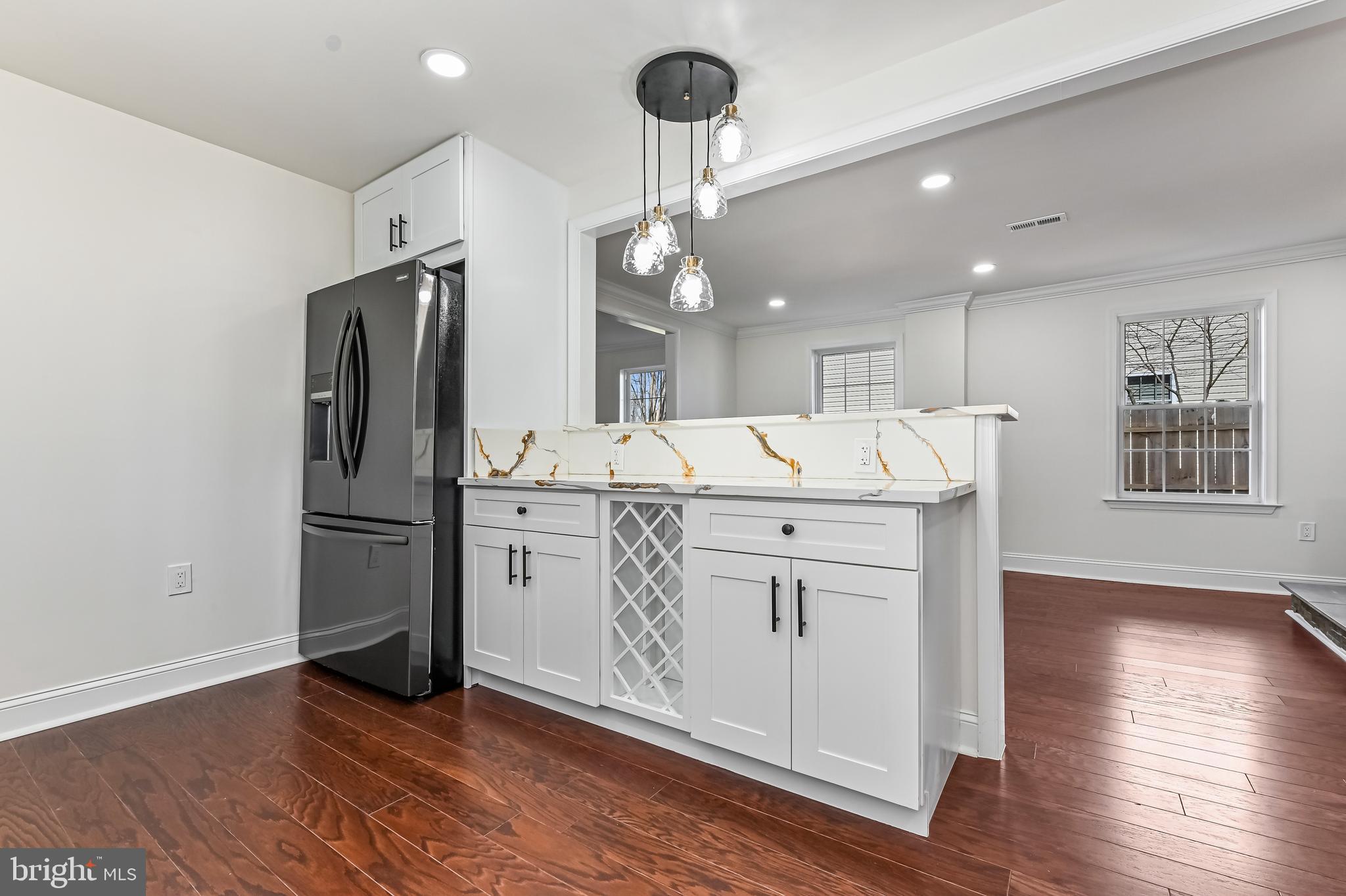 1637 Fairhill Drive Edgewater, MD 21037 - Photo 10 of 46 a kitchen with kitchen island white cabinets and stainless steel appliances