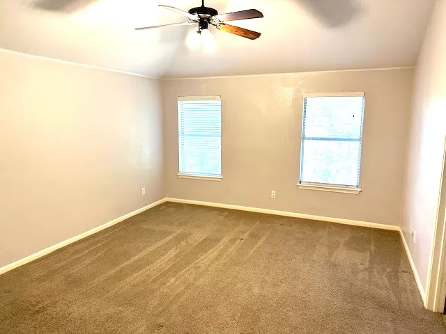 a spacious bathroom with a tub sink and mirror