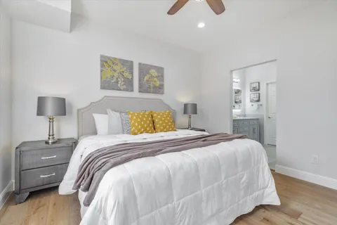 a bedroom with a bed and a night stand