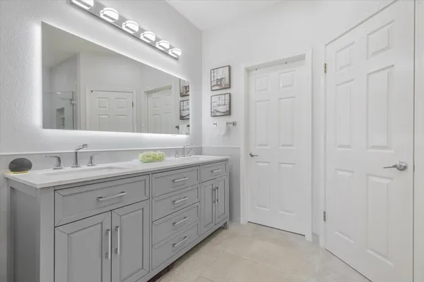 a bathroom with a granite countertop sink mirror and double