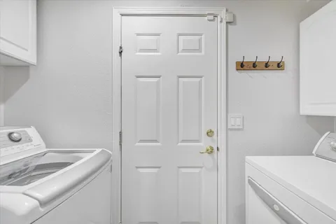 a view of storage and utility room with washer and dryer