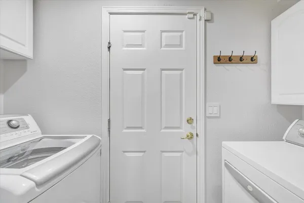a view of storage and utility room with washer and dryer