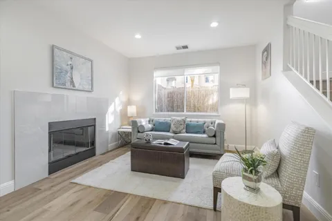a living room with furniture and a fireplace