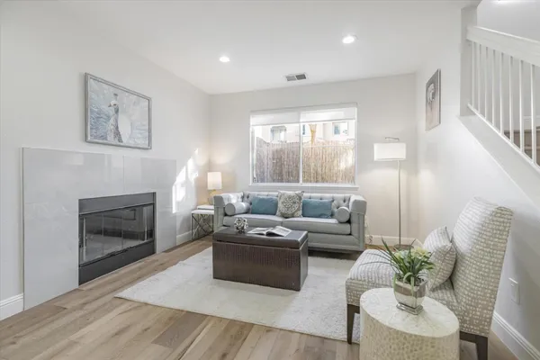 a living room with furniture and a fireplace