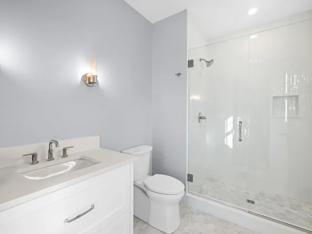 a bathroom with a bathtub a sink and a window