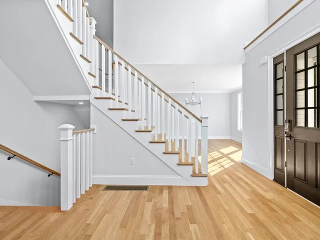 a view of entryway and hall with wooden floor