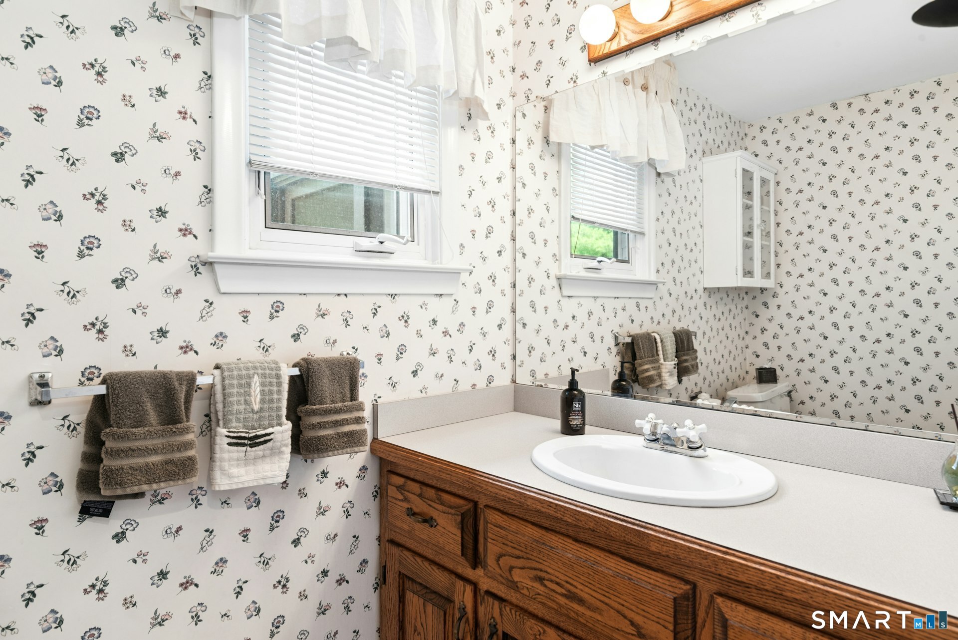127 Huntingtown Road Newtown, CT 06470 - Photo 16 of 38 a bathroom with a sink and a mirror