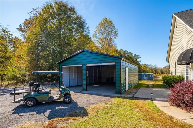 a view of a house with a patio and a yard