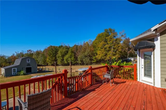 a view of a balcony with wooden floor and fence
