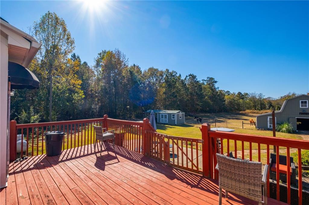 230 Mt Pleasant Road Hampton, GA 30228 - Photo 28 of 51 a view of a balcony with wooden floor and fence