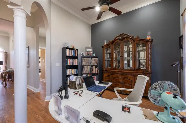 a view of a livingroom with furniture and a book shelf