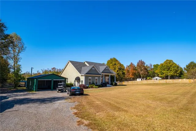 a view of house with outdoor space and seating area