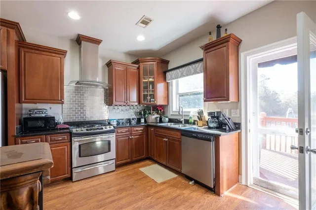 a kitchen with cabinets and stainless steel appliances
