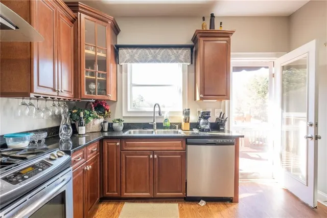 a view of a hallway with wooden floor and closet