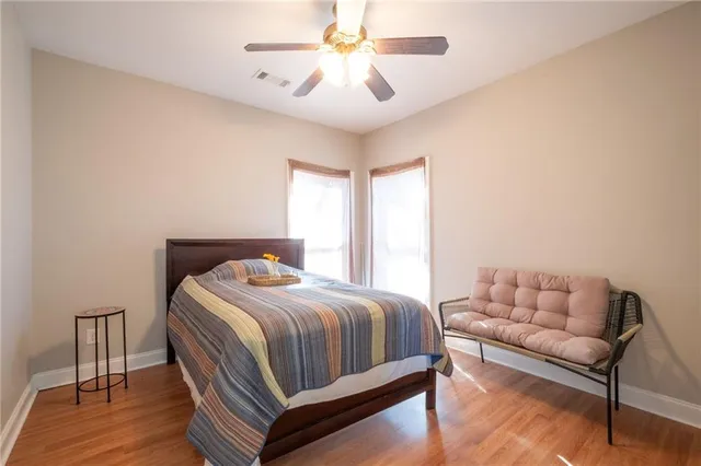 a bedroom with a bed and a ceiling fan