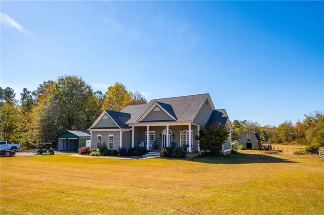 a front view of house with yard and swimming pool