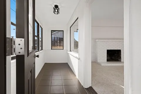 a kitchen with granite countertop white cabinets and white stainless steel appliances