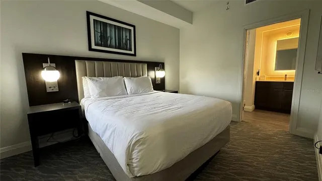 a bedroom with a bed and a lamp