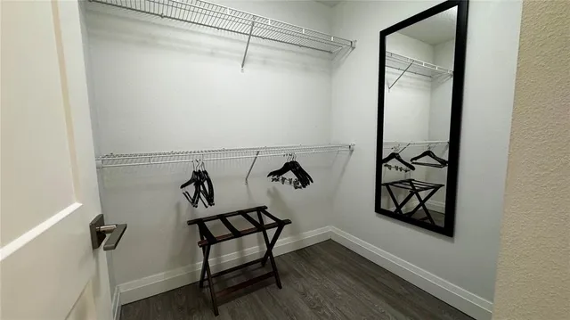 a view of a room with rack on the wall and a window