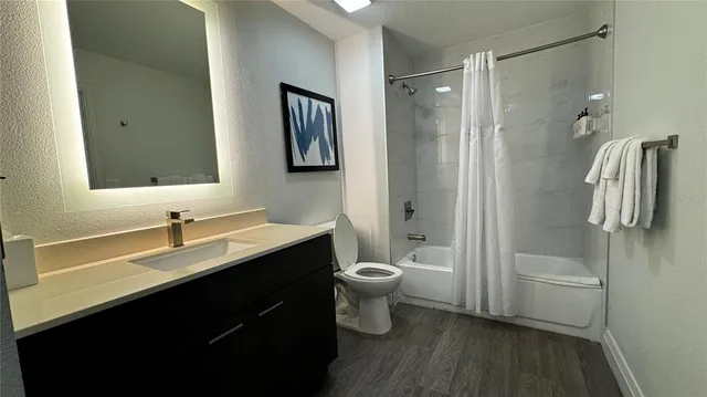 a bathroom with a double vanity sink toilet and shower