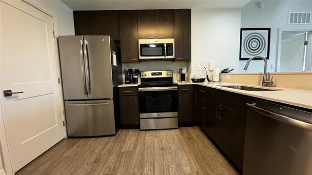 a kitchen with a sink and a refrigerator