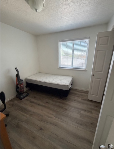 72 300 North, Unit 302 Provo, UT 84601 - Photo 14 of 16 Room featuring wood-finish flooring, a window with blinds, and white walls