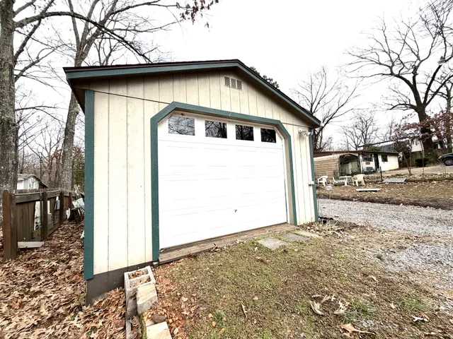 a white house that has tree in front of it