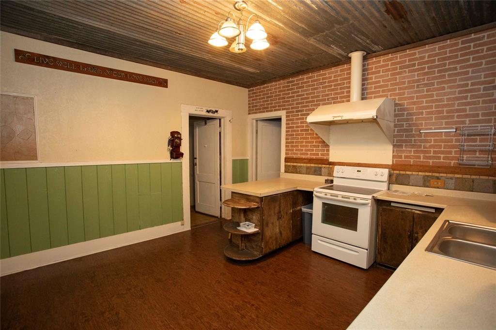 1311 Loving Highway Graham, TX 76450 - Photo 12 of 31 a kitchen with cabinets and stainless steel appliances