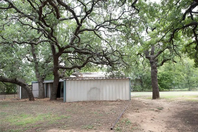 a wooden house with trees in front of it
