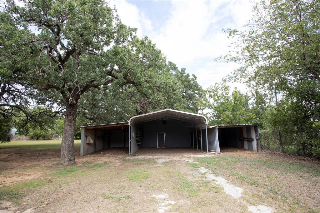 1311 Loving Highway Graham, TX 76450 - Photo 7 of 31 a front view of a house with a yard and garage