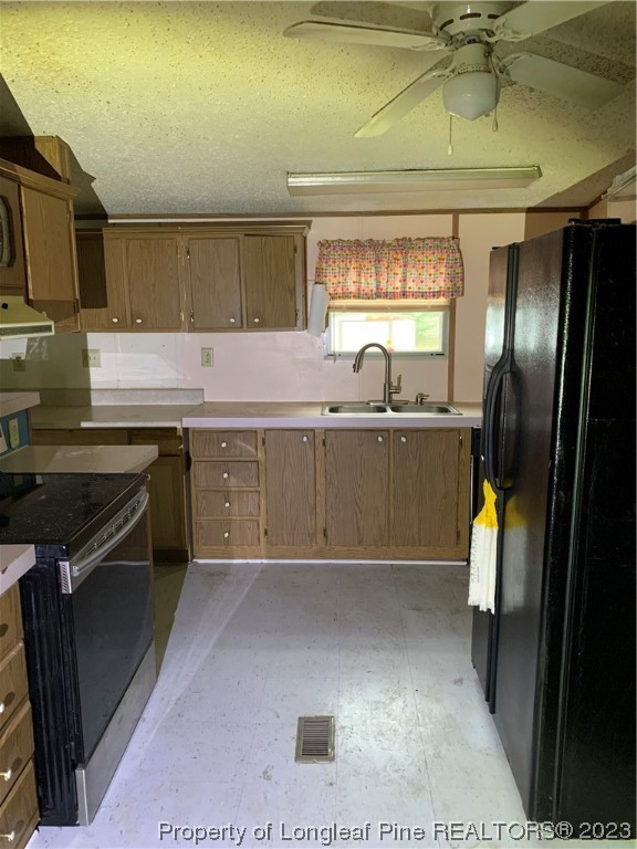 6400 Waldos Beach Road Fayetteville, NC 28306 - Photo 7 of 29 a kitchen with stainless steel appliances granite countertop a sink stove and refrigerator