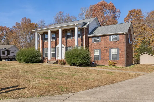 a front view of a house with a yard