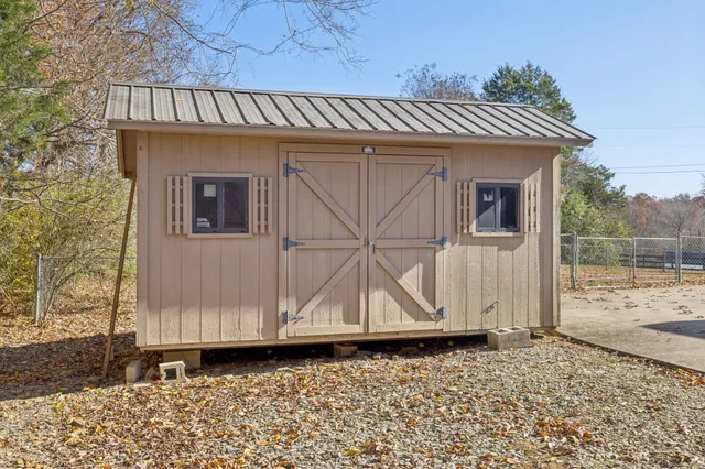 a view of a house with a wooden deck
