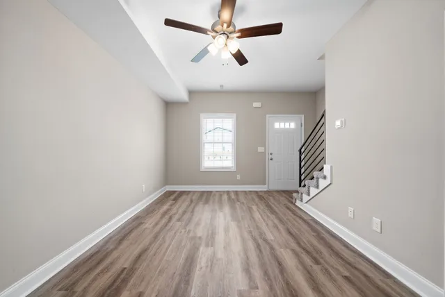 wooden floor in an empty room with a window