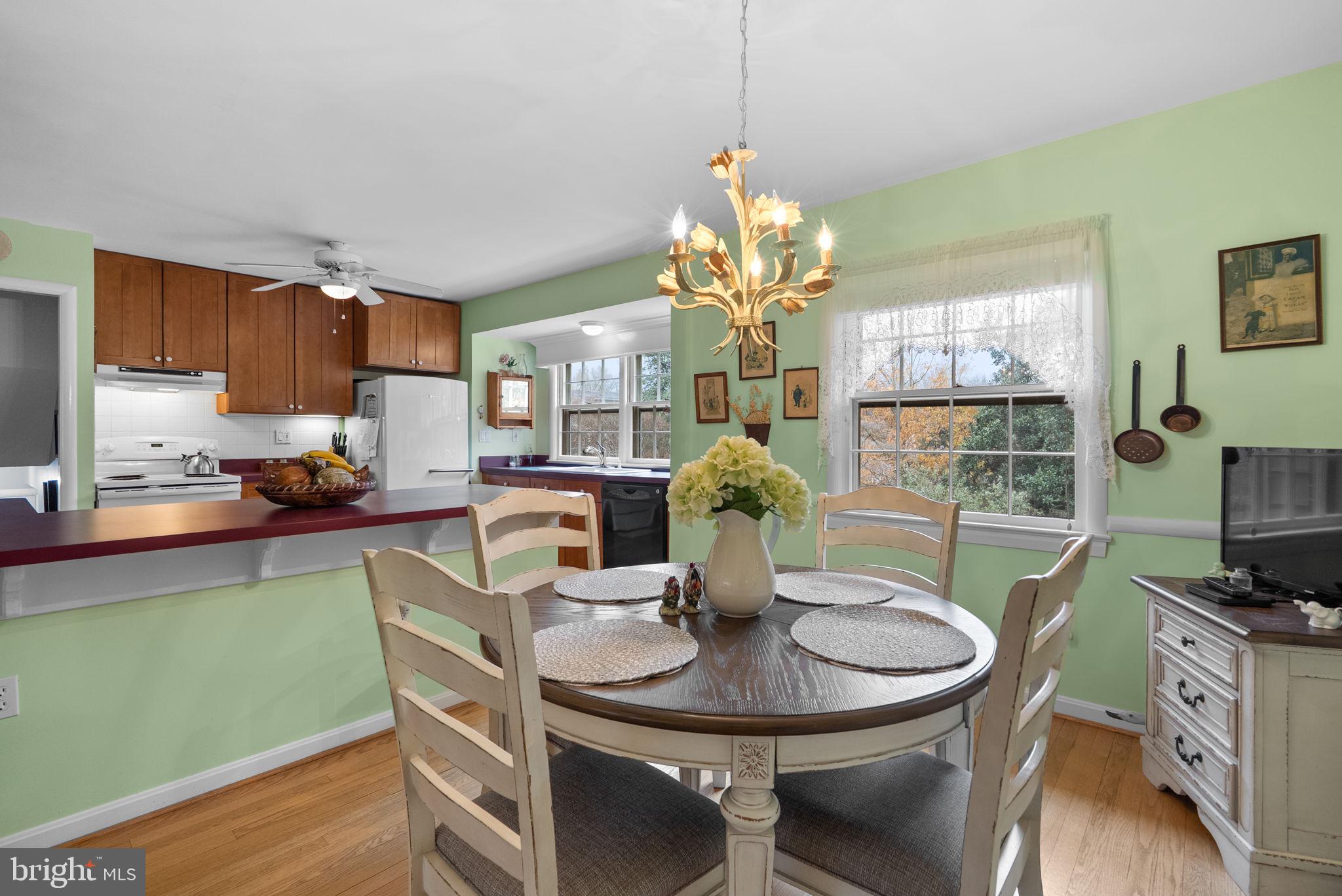 14004 Zeigler Way Silver Spring, MD 20904 - Photo 6 of 57 a view of a dining room with furniture a kitchen and chandelier
