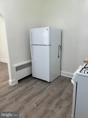 a view of a room with wooden floor and a sink