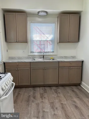 a kitchen with sink cabinets and window