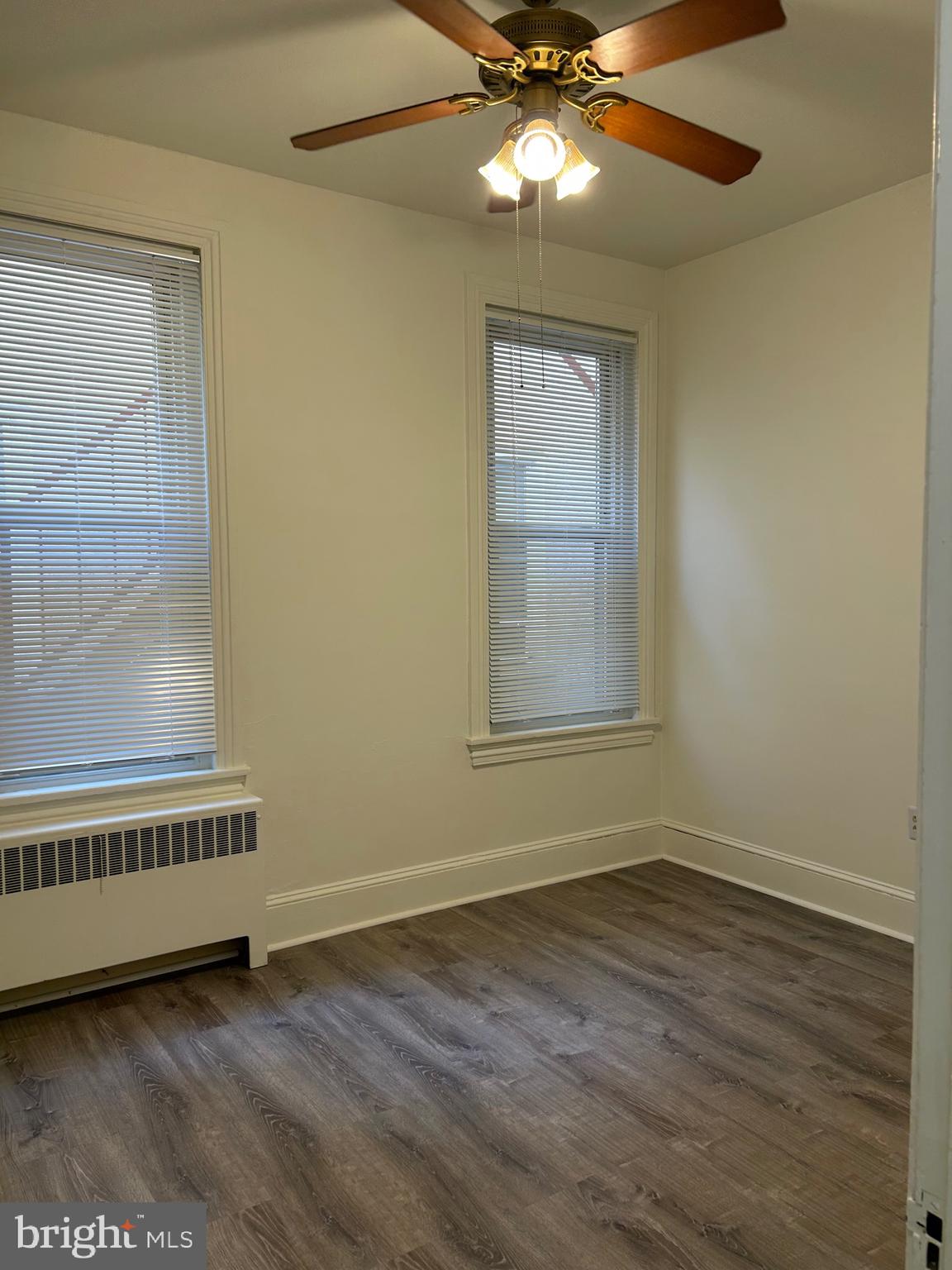 206 West Gay Street, Unit 1 West Chester, PA 19380 - Photo 5 of 14 a view of an empty room with a window and wooden floor